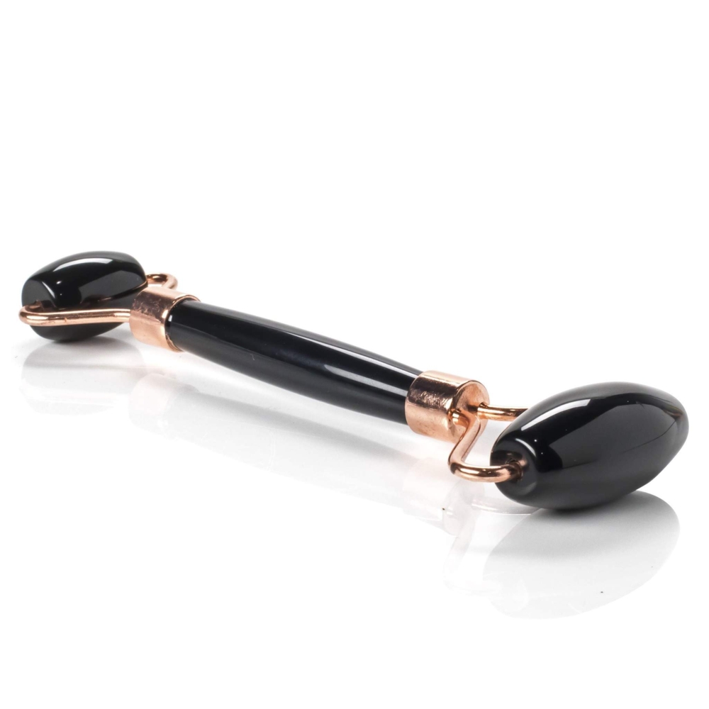 <font size="4"><span style="font-family: "EB Garamond";">Black Onyx Facial Roller With Rose Gold Hardware</span></font><div style="position: initial; margin: initial; font-family: "EB Garamond";"><font size="4"><br style="position: initial; margin: initial; font-family: "EB Garamond";"></font></div><div style="position: initial; margin: initial; font-family: "EB Garamond";"><p style="margin: initial; padding: 0px; border: 0px; font-variant-numeric: inherit; font-variant-east-asian: inherit; font-stretch: inherit; line-height: inherit; font-family: "EB Garamond"; vertical-align: baseline; color: rgb(51, 51, 51); position: initial;"><font size="4">Natural Black Onyx face roller that assists lymphatic drainage to reduce the appearance of wrinkles, and puffiness. This roller acts as a massage tool for your face. You can use it alone or in conjunction with your skin care routine.</font></p><p style="margin: initial; padding: 0px; border: 0px; font-variant-numeric: inherit; font-variant-east-asian: inherit; font-stretch: inherit; line-height: inherit; font-family: "EB Garamond"; vertical-align: baseline; color: rgb(51, 51, 51); position: initial;"><font size="4">Black Onyx is a natural healing stone used to protect one against negativity and ease stress.</font></p><p style="margin: initial; padding: 0px; border: 0px; font-variant-numeric: inherit; font-variant-east-asian: inherit; font-stretch: inherit; line-height: inherit; font-family: "EB Garamond"; vertical-align: baseline; color: rgb(51, 51, 51); position: initial;"><font size="4">Face rollers are excellent in assisting with the following:</font></p><ul style="margin: initial; padding: 0px; border: 0px; font-variant-numeric: inherit; font-variant-east-asian: inherit; font-stretch: inherit; line-height: inherit; font-family: "EB Garamond"; vertical-align: baseline; color: rgb(51, 51, 51); position: initial;"><li style="margin: initial; padding: 0px; border: 0px; font-style: inherit; font-variant: inherit; font-weight: inherit; font-stretch: inherit; line-height: inherit; font-family: "EB Garamond"; vertical-align: baseline; list-style: outside disc; position: initial;"><font size="4">Helps fight wrinkles </font></li><li style="margin: initial; padding: 0px; border: 0px; font-style: inherit; font-variant: inherit; font-weight: inherit; font-stretch: inherit; line-height: inherit; font-family: "EB Garamond"; vertical-align: baseline; list-style: outside disc; position: initial;"><font size="4">Helps blood circulation to the face, and assists in detoxification </font></li><li style="margin: initial; padding: 0px; border: 0px; font-style: inherit; font-variant: inherit; font-weight: inherit; font-stretch: inherit; line-height: inherit; font-family: "EB Garamond"; vertical-align: baseline; list-style: outside disc; position: initial;"><font size="4">Decreases puffiness under eyes and around face</font></li><li style="margin: initial; padding: 0px; border: 0px; font-style: inherit; font-variant: inherit; font-weight: inherit; font-stretch: inherit; line-height: inherit; font-family: "EB Garamond"; vertical-align: baseline; list-style: outside disc; position: initial;"><font size="4">Brings a natural glow to your face</font></li><li style="margin: initial; padding: 0px; border: 0px; font-style: inherit; font-variant: inherit; font-weight: inherit; font-stretch: inherit; line-height: inherit; font-family: "EB Garamond"; vertical-align: baseline; list-style: outside disc; position: initial;"><font size="4">Helps tighten skin, making it appear more youthful</font></li><li style="margin: initial; padding: 0px; border: 0px; font-style: inherit; font-variant: inherit; font-weight: inherit; font-stretch: inherit; line-height: inherit; font-family: "EB Garamond"; vertical-align: baseline; list-style: outside disc; position: initial;"><font size="4">Helps absorb moisturizers and serums more fully</font></li></ul><p style="margin: initial; padding: 0px; border: 0px; font-variant-numeric: inherit; font-variant-east-asian: inherit; font-stretch: inherit; line-height: inherit; font-family: "EB Garamond"; vertical-align: baseline; color: rgb(51, 51, 51); position: initial;"><font size="4">As each stone is one of a kind and unique, please allow for variations in color and texture in the face roller that you receive versus the one photographed. Your satisfaction is 100% guaranteed or your money back.</font></p><p style="margin: initial; padding: 0px; border: 0px; font-variant-numeric: inherit; font-variant-east-asian: inherit; font-stretch: inherit; line-height: inherit; font-family: "EB Garamond"; vertical-align: baseline; color: rgb(51, 51, 51); position: initial;"><font size="4">Length: 6 inches.</font></p><p style="margin: initial; padding: 0px; border: 0px; font-variant-numeric: inherit; font-variant-east-asian: inherit; font-stretch: inherit; line-height: inherit; font-family: "EB Garamond"; vertical-align: baseline; color: rgb(51, 51, 51); position: initial;"><font size="4">Width: 2 inches.</font></p></div> Black Onyx Facial Roller With Rose Gold Hardware