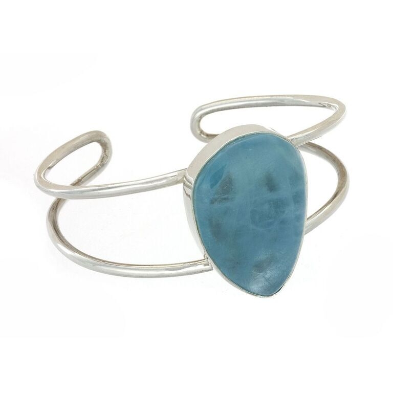 <font size="4"><font style="font-family: "EB Garamond";">This Aquamarine cabochon cuff is a bright Jewel. The Gemstone is Polished in a free-form shape, making it a One-of-a-Kind Versatile Jewelry Piece. Set in Sterling Silver, this simple and stunning cuff </font><span style="font-family: "EB Garamond";">evokes</span><font style="font-family: "EB Garamond";"> a happy smile upon all faces that it encounters.</font></font> Aquamarine Cuff -Single Simple Bezel Center
