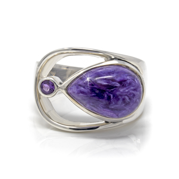 Closeup photo of Charoite Ring Size 9 - Pear Cabochon With Faceted Amethyst Round & Silver Bezels Set On Open Band Top