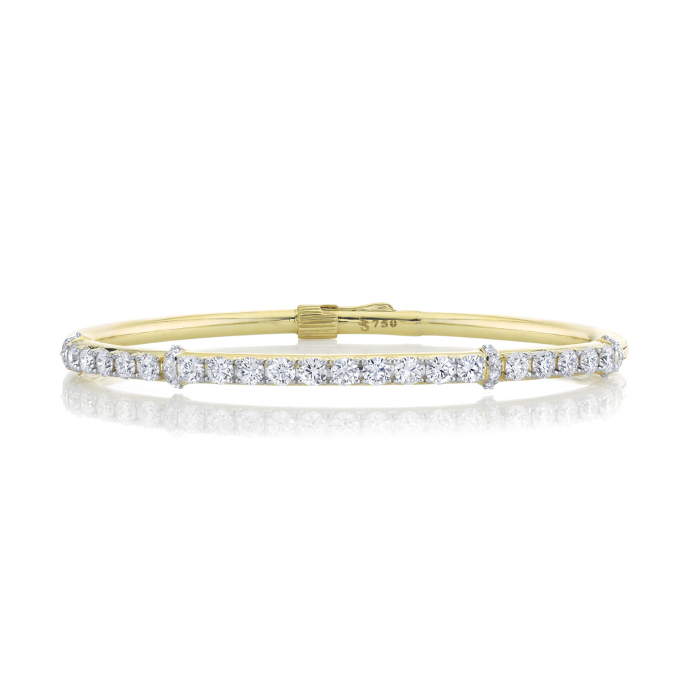 SLOANE STREET WHITE DIAMOND BANGLE BRACELET IN 18K YELLOW GOLD FEATURES 2.29TCW OF 36 3MM BRILLIANT WHITE DIAMONDS WITH DOUBLE HINGE AND HIDDEN LOCKING CLASP. THIS SHOWSTOPPING CUFF CREATES A TIMELESS AND EFFORTLESS LOOK WHILE REMAINING DELICATE AND FEMININE. Classic Diamond Bangle