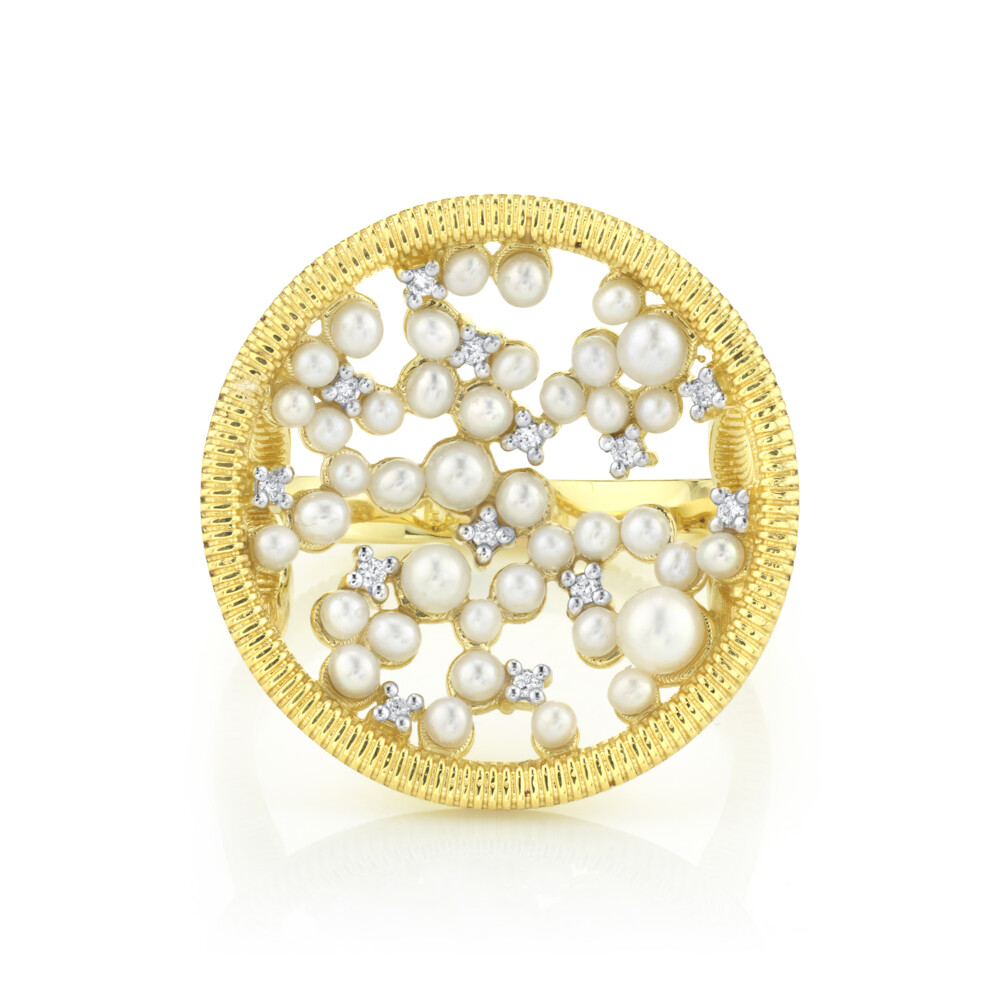 SLOANE STREET ROUND CELESTIAL COLLECTION WHITE PEARL AND DIAMOND PAVE RING IN 18K YELLOW GOLD. FEATURES A UNIQUE STRIE TEXTURED EDGE DETAIL AND A SKY-LIKE CARPET OF GRADUATED WHITE DIAMONDS IN A SLIGHTLY CONCAVE PLANE, GIVING DEPTH TO THE THIS UNIQUE STATEMENT COCKTAIL RING, THAT ADDS GLAMOUR AND SPARKLE TO ANY OUTFIT. Celestial Seed Pearl And Diamond Ring