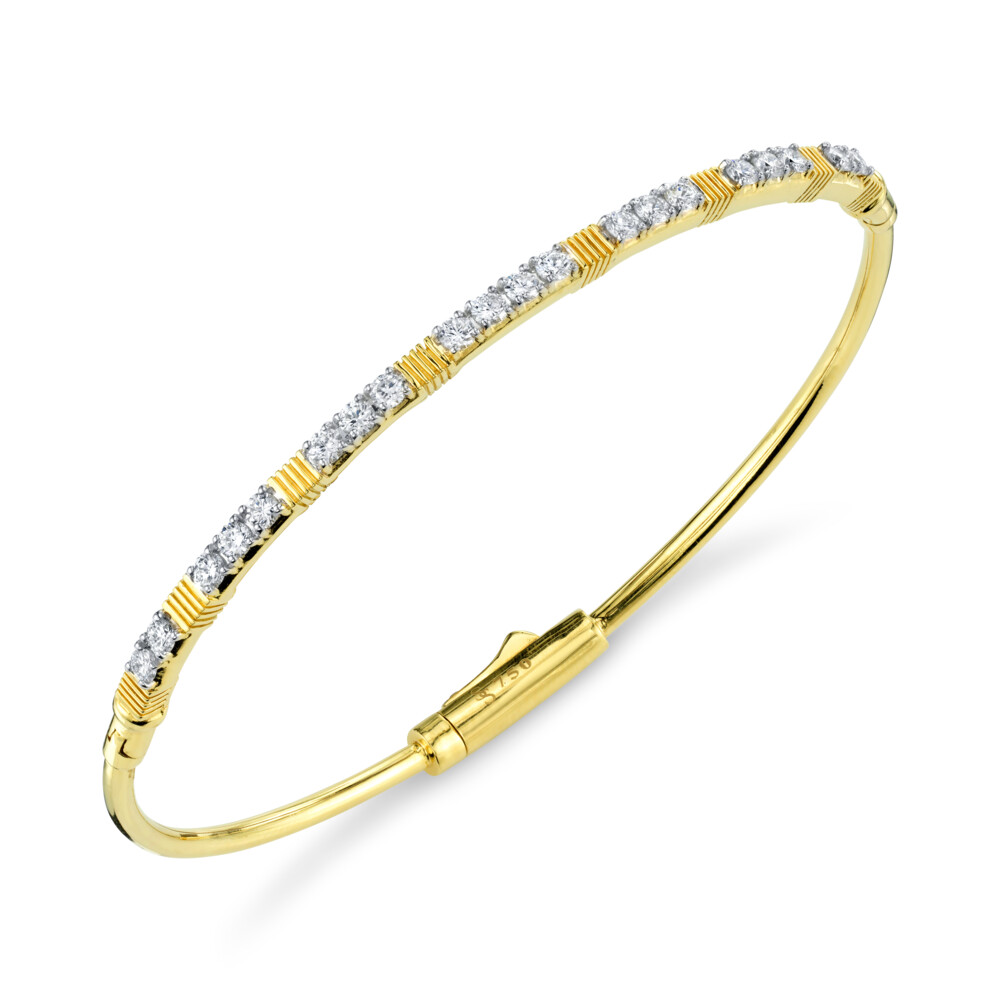 SLOANE STREET WHITE DIAMOND AND STRIE BRACELET FEATURES RICH STATIONS OF OUR SIGNATURE STRIE TEXTURE BROKEN UP BY INLINE SPARKLING WHITE DIAMONDS IN 18K YELLOW GOLD. THIS EFFORTLESSLY CHIC BRACELET IS A CLASSIC STAPLE FOR ANY WARDROBE AND EASY-TO-USE DOUBLE HINGE AND HIDDEN LOCKING CLASP ALLOWS FOR MAXIMUM VERSATILITY. DIAMOND AND STRIE BANGLE