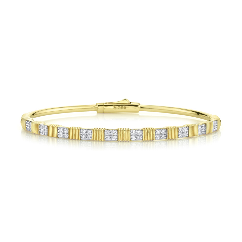SLOANE STREET CLASSIC PAVE WHITE DIAMOND BRACELET IN 18K YELLOW GOLD FEATURES WHITE DIAMOND CLUSTERS WITH WHITE RHODIUM SEPARATED BY RICH SIGNATURE STRIE STATIONS CREATING A VERSATILE TWO-TONE LOOK WITH DOUBLE HINGE AND HIDDEN CLASP CLOSURE. THIS TIMELESS BANGLE BRACELET IS A STRONG ASSET TO ANY STACK BUT IMPACTFUL ENOUGH TO BE WORN ON ITS OWN. Diamond And Strie Double Row Bangle