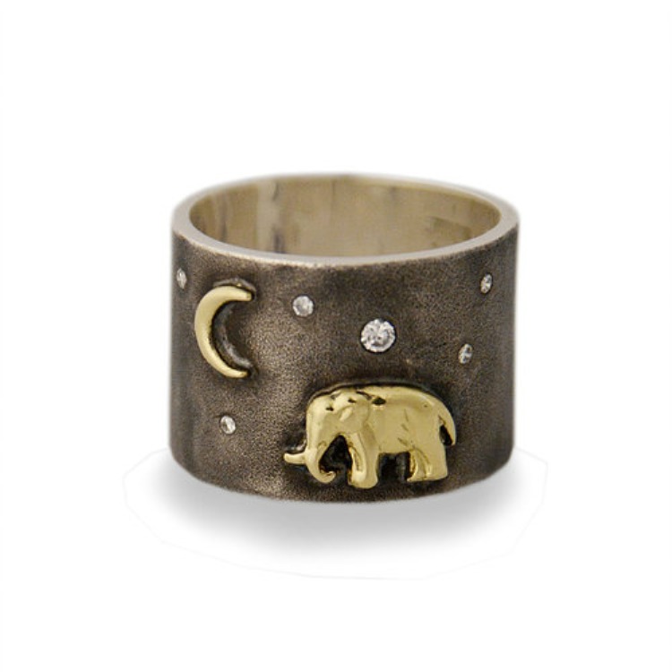 An 18K gold elephant stands majestic under the twinkling diamond sky. The Silver Tsavo Nights Ring features an 18K gold elephant and moon set on a wide band of oxidized silver. Silver Tsavo Nights Ring