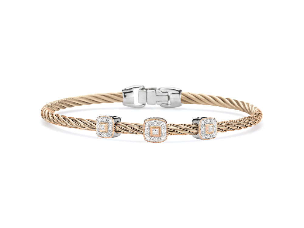 This heat treated carnation colored steel cable features three squared 18k rose gold stations. With a total diamond weight of .14cts this lightweight bangle is perfect to pair with a couple more or just to wear alone for a simple elegance. Carnation Three Squared Station Bangle