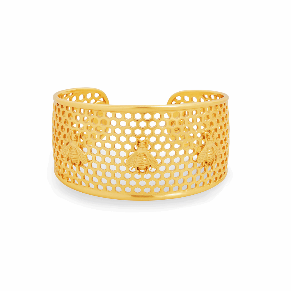 Whimsical bees decorate a statement honeycomb cuff. Adjustable to fit all wrists. Honeycomb Cuff