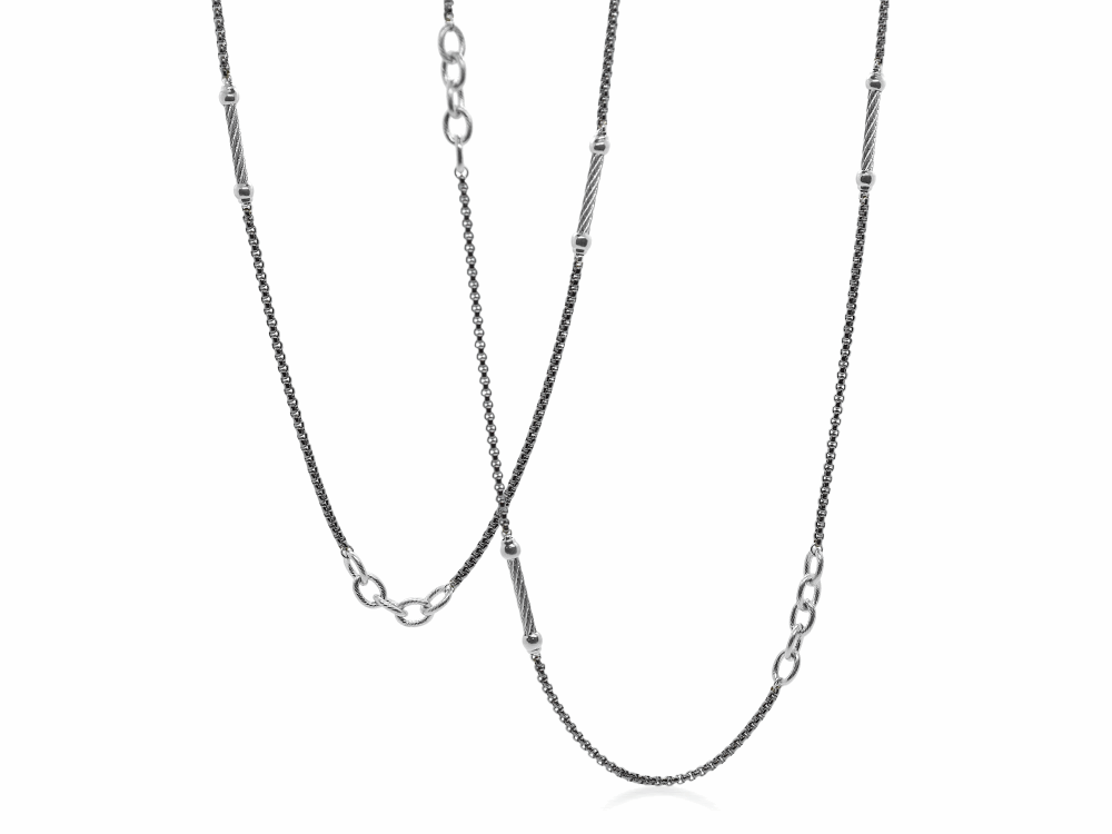 <div>This mixed metal necklace features black and grey colored stainless steel. Displaying three types of metals: a link chain, a long bar, and a tight chain in black. This necklace can be worn doubled, or as just the single strand. This is perfect to wear casually during the day, or dressed up to be worn with something a bit more formal. </div> Noir Chain Reaction Black Steel Ball and Open Link Necklace