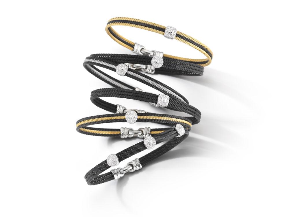 This noir heat treated steel cable features three strands of cable fused together. Displaying three 18k white gold diamond circled stations with a total carat diamond weight of .14 carats. This bangle is perfect stacked with others, or adds a simple elegance to any outfit when worn alone. Noir Three Circled Station Bangle