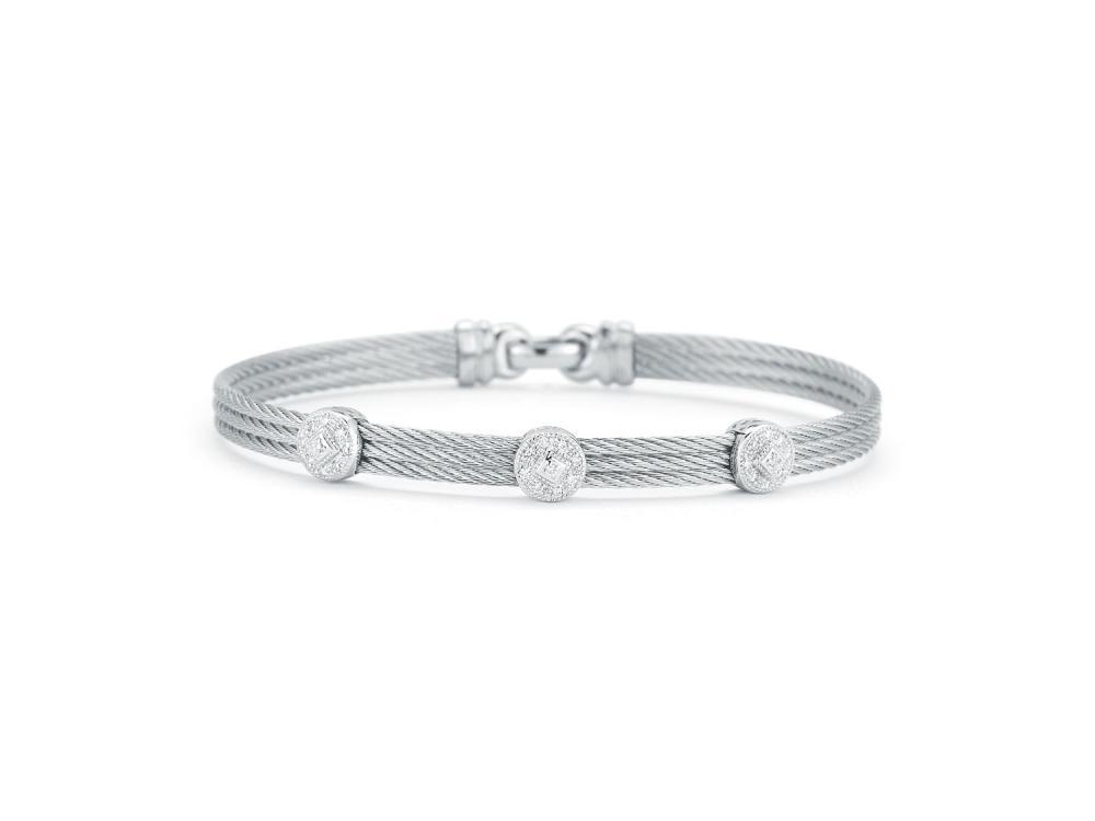 This heat treated grey colored steel cable features 3 strands of cable, displaying three circle diamond stations made of 18k white gold with a total diamond weight of .14 carats. This bracelet is perfect when stacked with others, or has a simple elegance when worn alone. Classique Three Circled Station Bangle