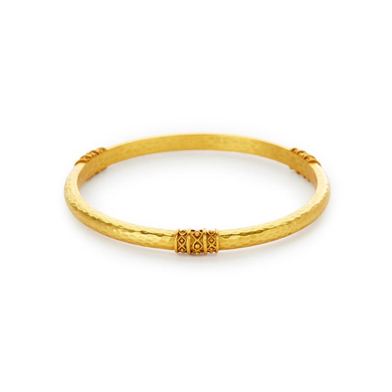 Our Catalina Bangle is a classic bangle with a glistening hammered finish, decorated with a bead-in-diamond motif and plated with 24k gold. Shop now: Catalina Bangle
