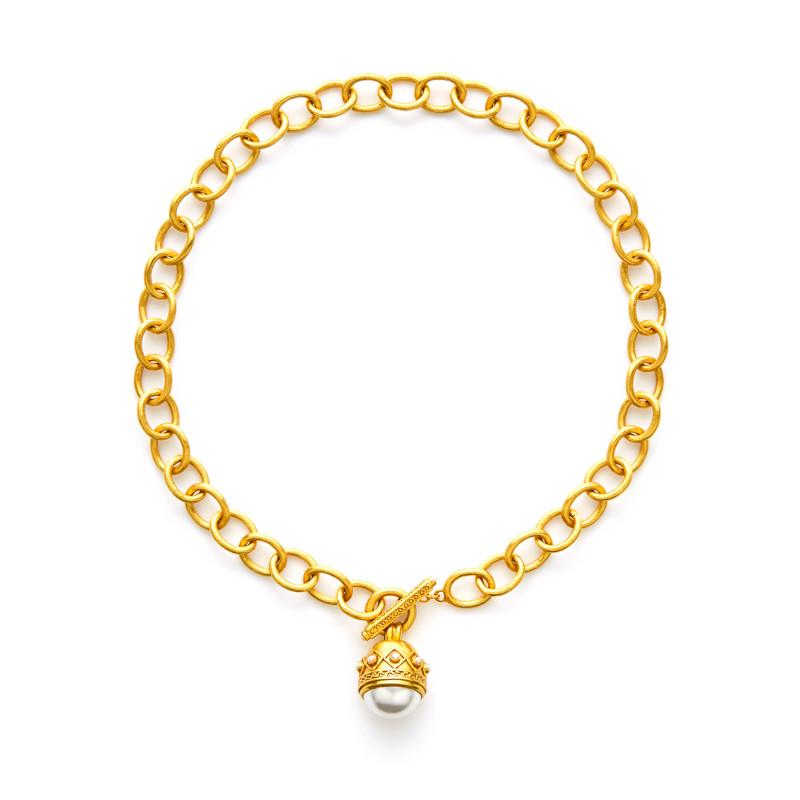 A shimmering cabochon, capped with the Medici raised diamond and dot detail, is suspended from a finely scored link. Front toggle features tiny freshwater pearl endcaps. Medici Statement Necklace