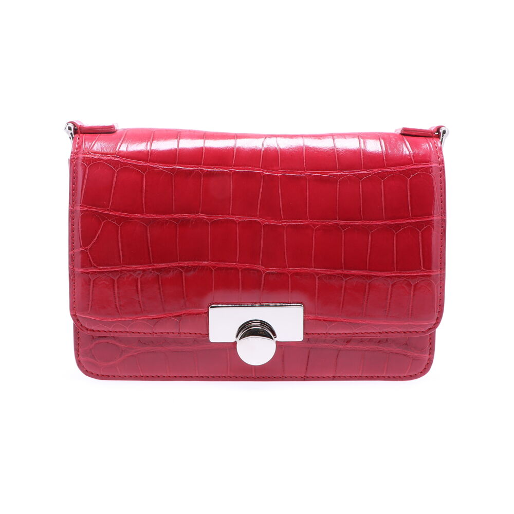 This unique and vibrant ruby red colored alligator purse is a true statement piece. This bold bag can either be worn as a clutch or over the shoulder bag. This bag is perfect for any occasion, whether meeting friends for lunch or a night out on the town, this purse is sure to impress. Ruby Red Alligator Chain Bag