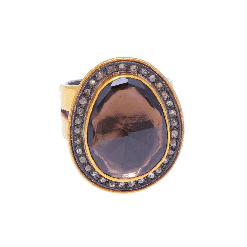 This stunning piece can easily be worn as an every-day piece. Crafted using 24k yellow gold, Sterling Silver, Champagne Diamonds, and featuring a Smoky Quartz gem. This gorgeous ring made by the Turkish designer Kurtulan, is casual enough to wear with jeans but elegant enough to be worn for a night out on the town. This ring has been imported from Turkey. Kurtulan Smoky Quartz Ring 24k Gold with Diamonds