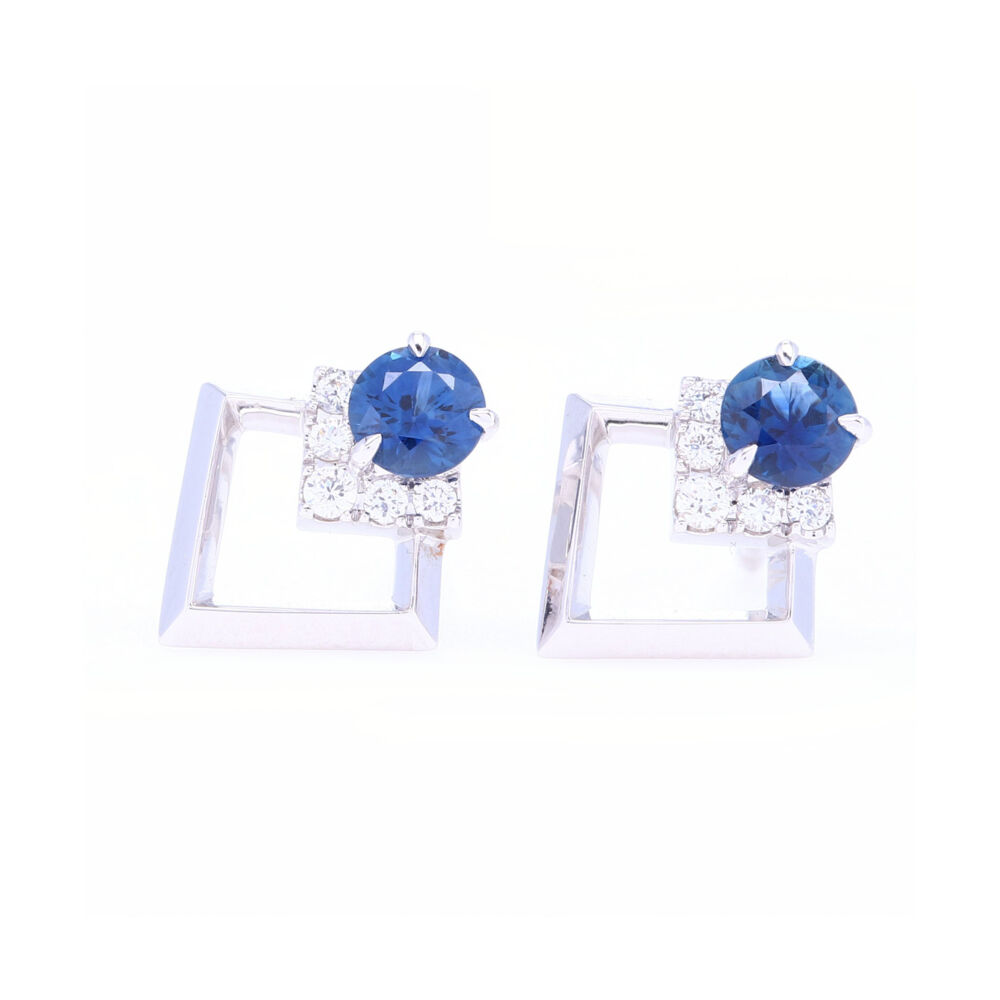 These 18K white gold stud earrings are set with a 3.5 mm round sapphires accented with a row of diamonds. Designed in New York City, these will be your new favorite everyday earrings. Contemporary Diamond and Blue Sapphire Studs