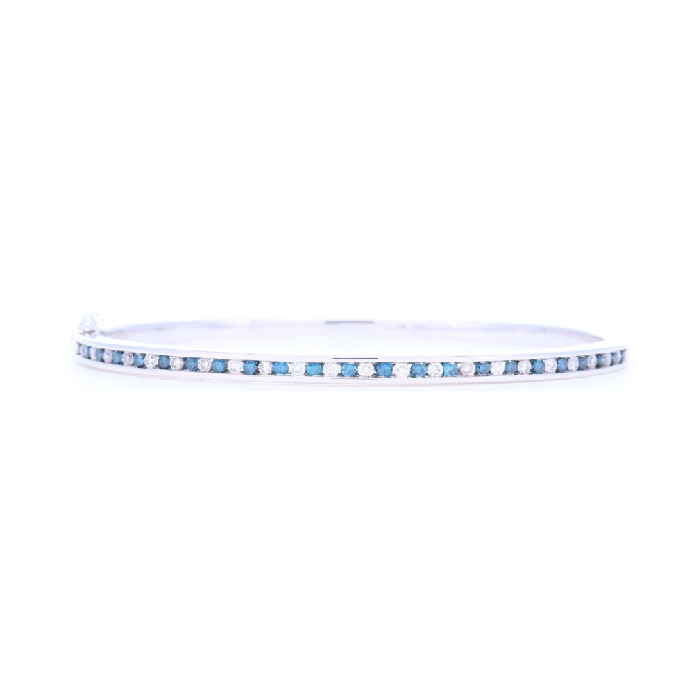 This 14k white gold blue and white diamond bangle has 1.1 carats of total round diamonds. This elegant bracelet is truly a classic and can be dressed up or down, worn stacked or alone, and be worn for any occasion. 14k White Gold Blue and White Diamond Bracelet