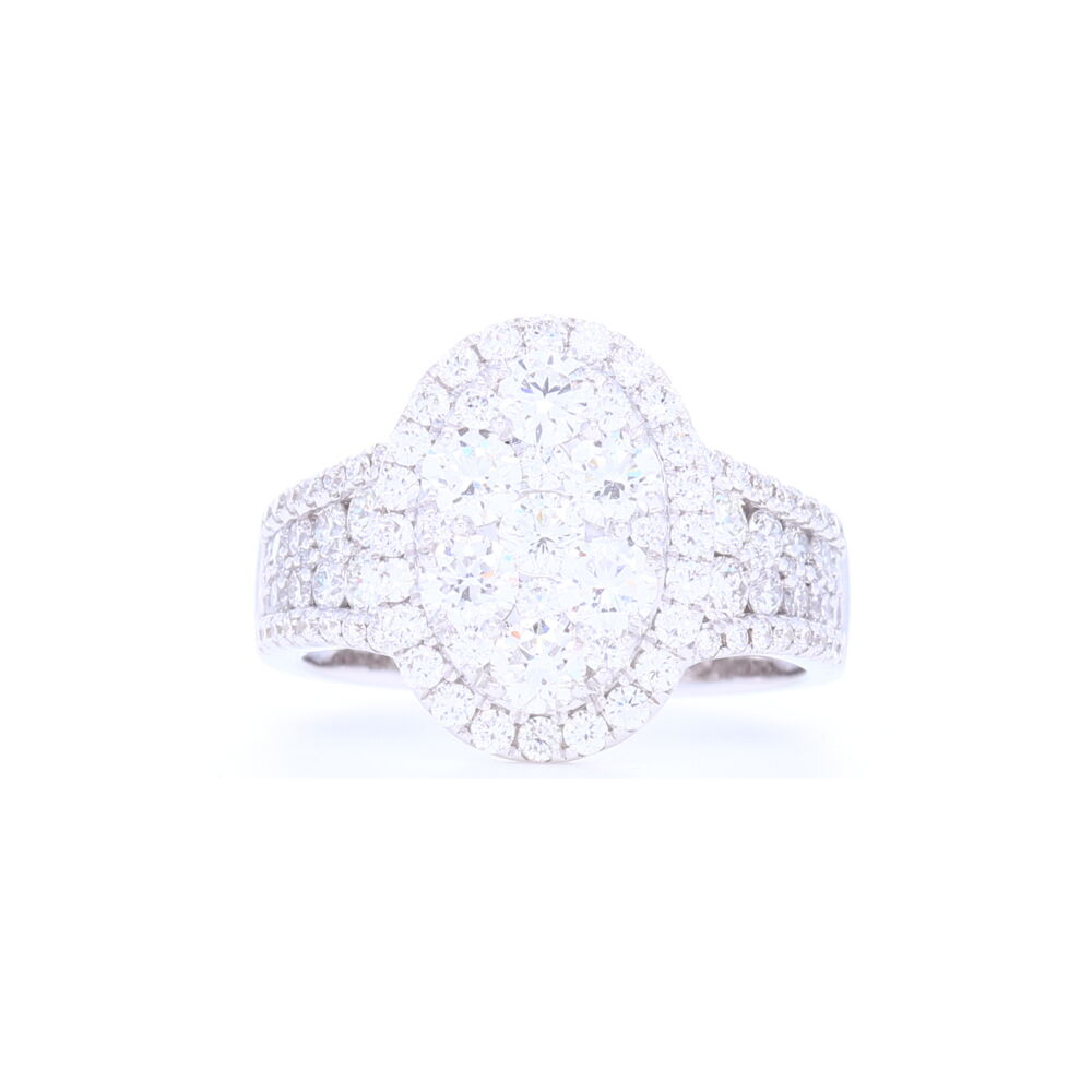 2 carats of brilliant cut diamonds make light explode in this clustered oval shaped ring with prong set diamonds down the shank. Set in 14k white gold this ring has a shank which sits narrow on the finger so that it's comfortable. 14k White Gold Oval Shaped Cluster Set Brilliant Cut Diamond Ring