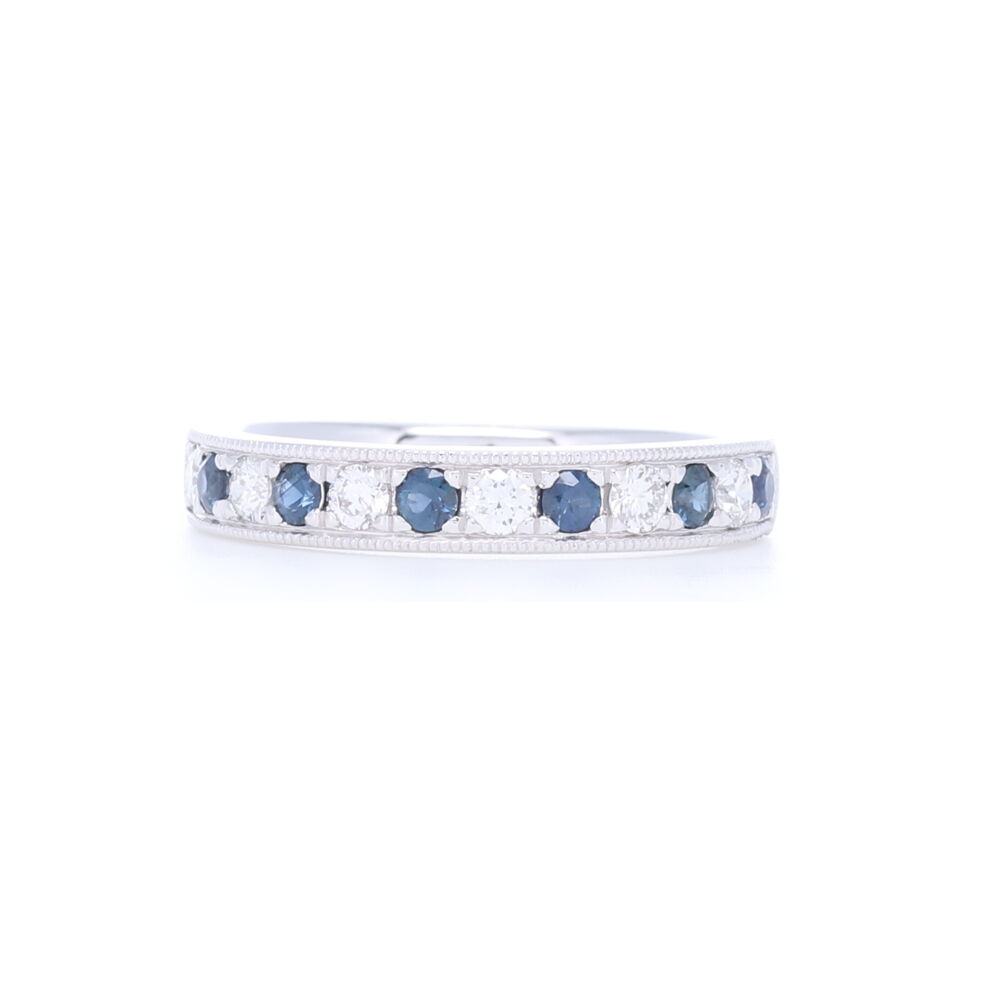 This prong and channel set round diamond and sapphire alternating 1/2 pattern stack ring is set into 14k white gold. This ring contains .26 carats of sapphires and .24 carats of diamonds. Timeless design to add to any stack ring set or engagement ring. Prong/Channel Round Diamond & Sapphire Ring in 14k White Gold