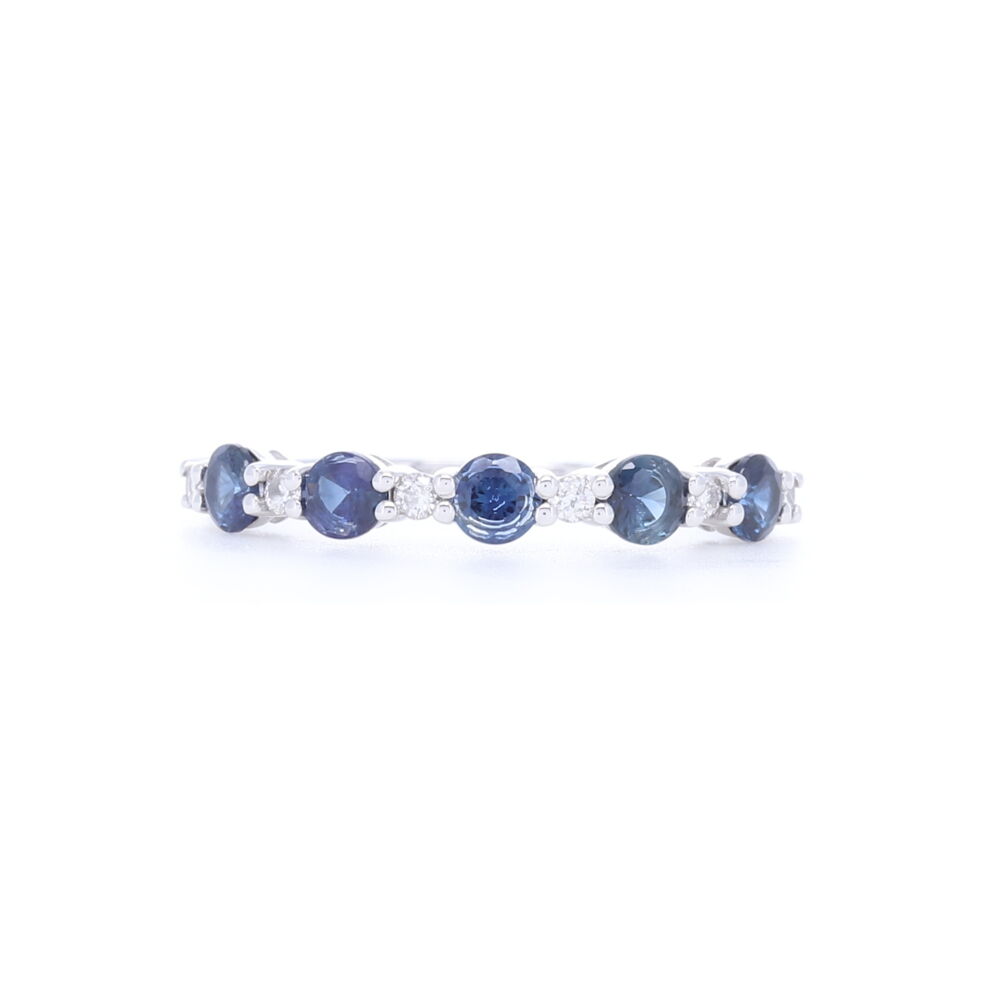 1/2 pattern alternating round cut diamonds and sapphires are set into this 14k white gold stack ring. Comfortable, affordable and a beautiful touch of color to add to any stack ring set or engagement ring. Diamond carat weight is .11 and Sapphire carat weight is .7 carats. Prong Set Round Diamond and Sapphire Stack Ring in 14k White Gold