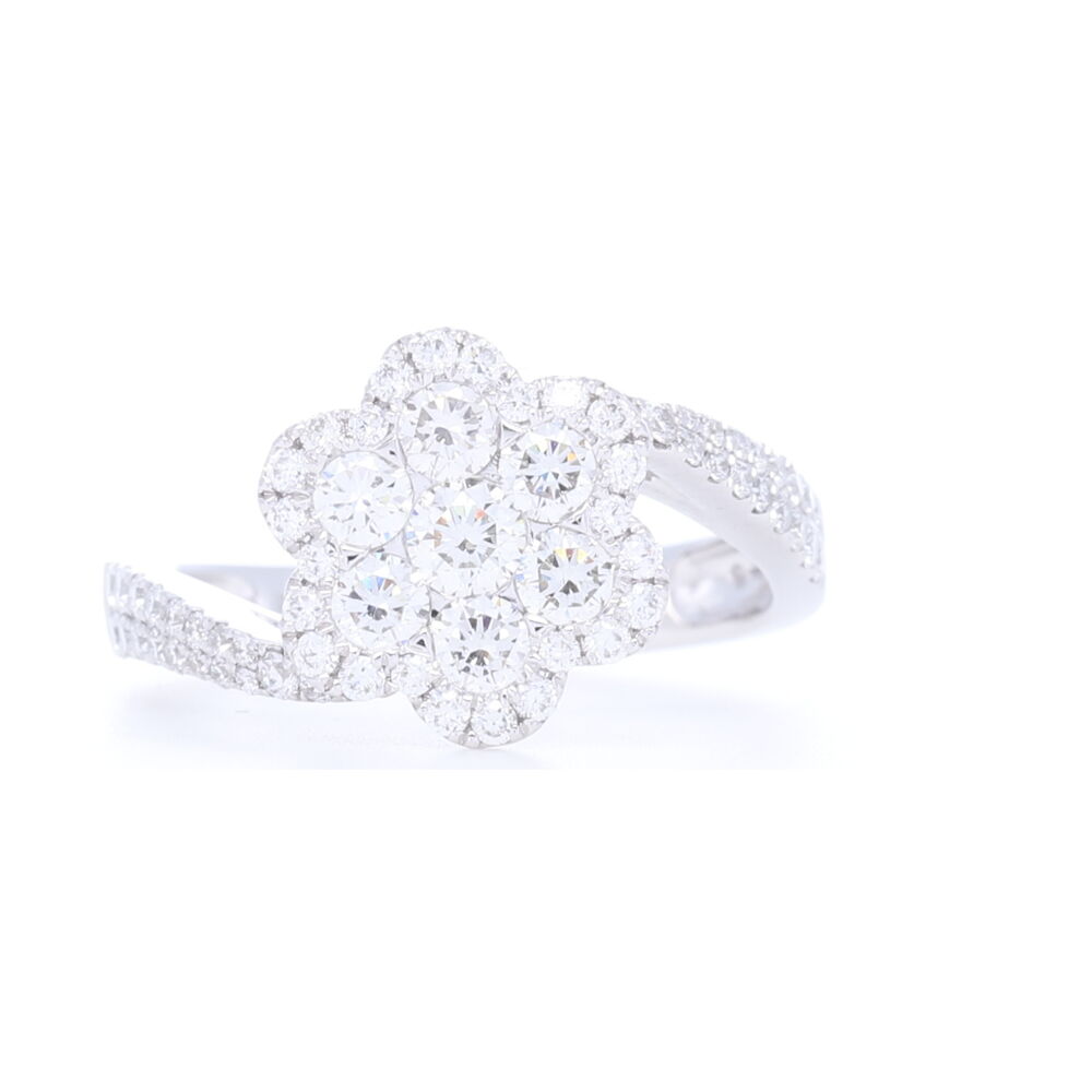 1.09 carats of diamonds are on display in this 14k white gold ring. The shank comes up in a twist highlighting a flower setting. Wonderfully comfortable, whimsical with tons of sparkle, this makes an amazing right or left hand. 14k White Gold Twist Round Diamond Flower Diamond Ring