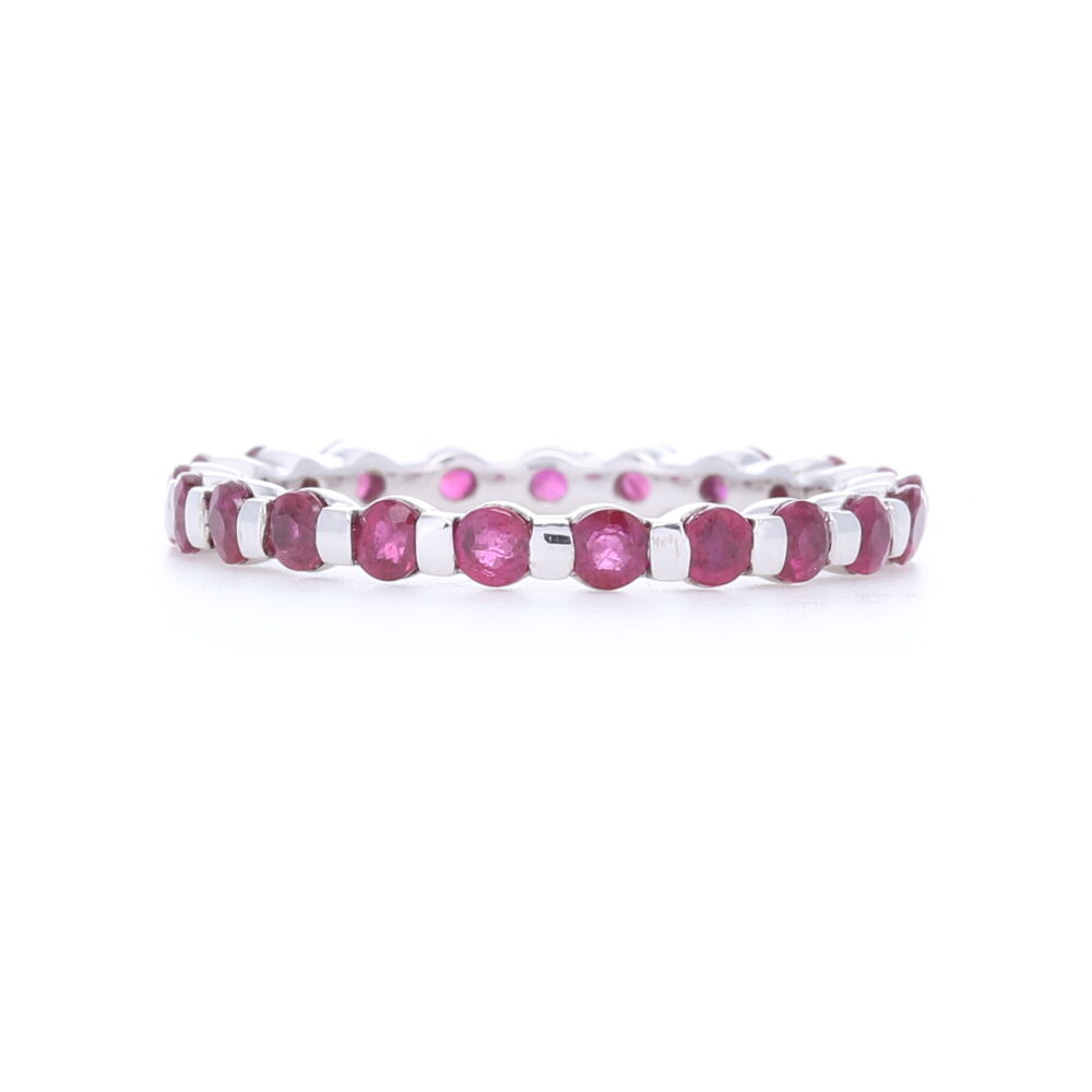 1.6 carats of round ruby stones make this stack ring a perfect addition to stack ring set needing color! Set in 14k white gold with a smooth bar setting, this won't snag on sweaters and can be worn alone, but plays well with others. 14k White Gold Bar Set Round Ruby Eternity Band