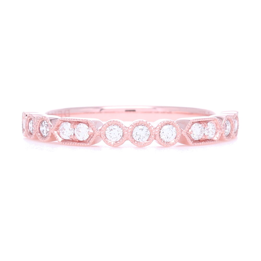 Interesting pattern and use of mixed settings make this a lovely addition to any stack ring set. Set in 14k rose gold, this ring looks amazing with platinum or white gold. Comfortable and not too wide, allows space for friends... Prong and Bezel Set Diamond Stack Ring set in 18k Rose Gold