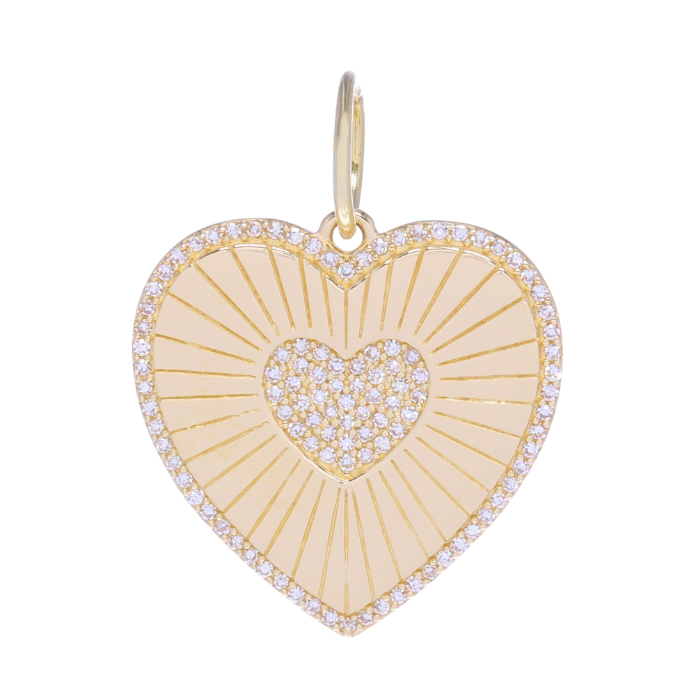 This beautiful heart shaped gold pendant is great for layering or it could be worn as a medallion all on it's own. This heart charm has grove details, 0.25 carats of diamonds and 2.7 grams of 14k gold. It would sweeten up any chain or set of charms, because we all know, charms need friends.
Gold Shine Diamond Heart Medallion Pendant