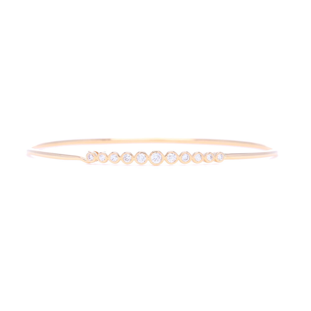 This 14k yellow gold bracelet, set with .3 carats of bezel set diamonds, is the perfect addition to your bangle collection. Whether worn separately or stacked, it is perfect for everyday wear or a night out on the town. 14k Yellow Gold Bezel Set Diamond Tension Hook Bracelet
