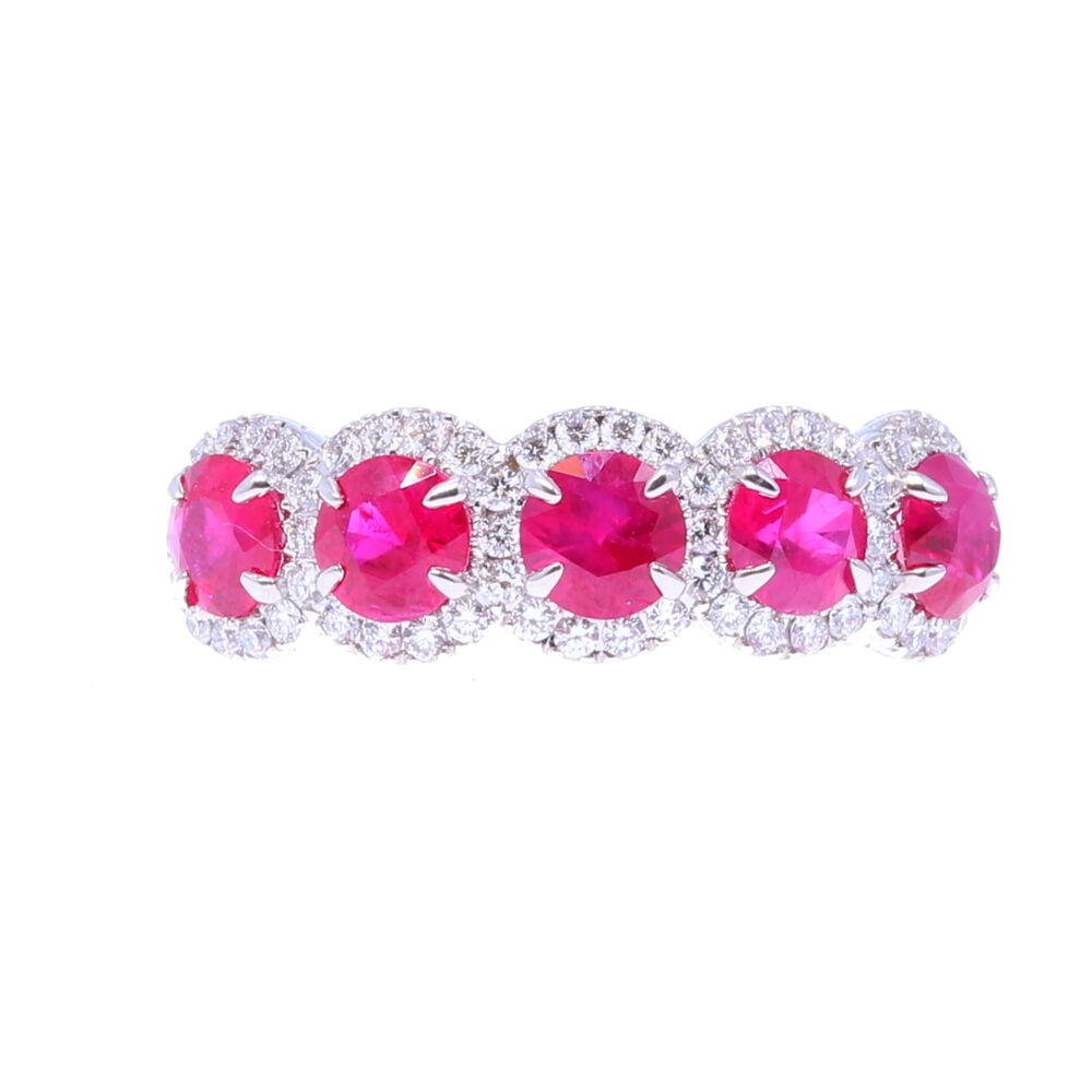A beautiful setting with 5 rubies; each one surrounded in a halo of diamonds. Ring is in 18k white gold. 5 Halo Set Ruby Stones
