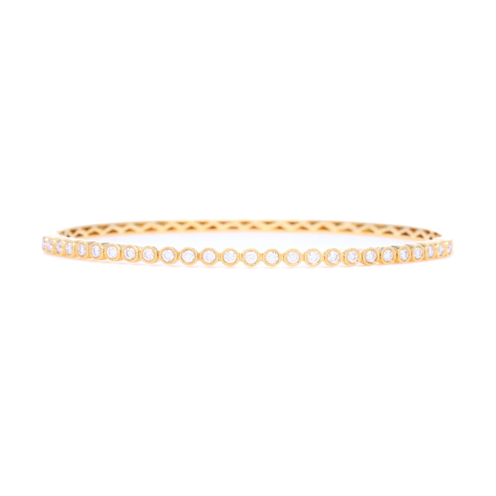 This 18k yellow gold bezel set diamond bangle is fits up to a 6.5 inch wrist and is the perfect addition to your jewelry collection. This bangle is perfect for stacking alongside other bracelets but is versatile enough to be worn alone as well. Whether you wear this bangle out on the town or day-to-day, its beauty is bound to turn heads.<div>Diamond weight: 0.57ct</div> 18k Yellow Gold Diamond Bezel Set Bangle