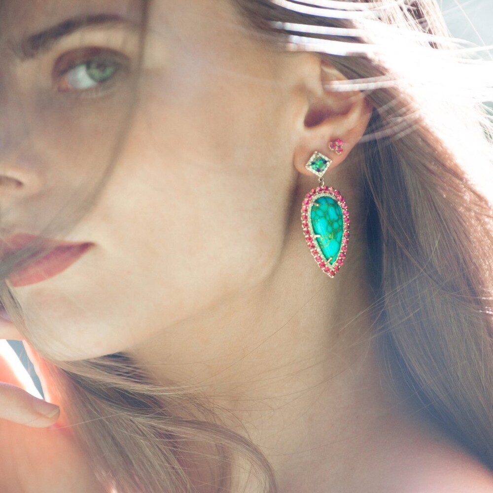 Eden Presley impresses with these stunning earrings crafted of Turquoise with Copper Veining surrounded by a double halo of Diamond & Spinel all dangling from a gorgeous Kyanite. These earrings measure 2" in length and 0.8" in width. One Of A Kind Copper Turquoise & Spinel Earrings