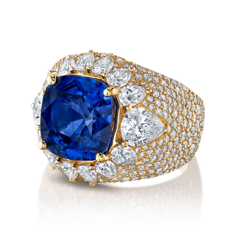 18k Yellow Gold dome ring featuring a 7.3ct blue sapphire framed by pear shape diamonds with diamond pave all over the ring. 417 Diamonds totaling 4.95tcw. Sapphire and two largest pear shape diamonds come with certificates Dome Ring - Sapphire
