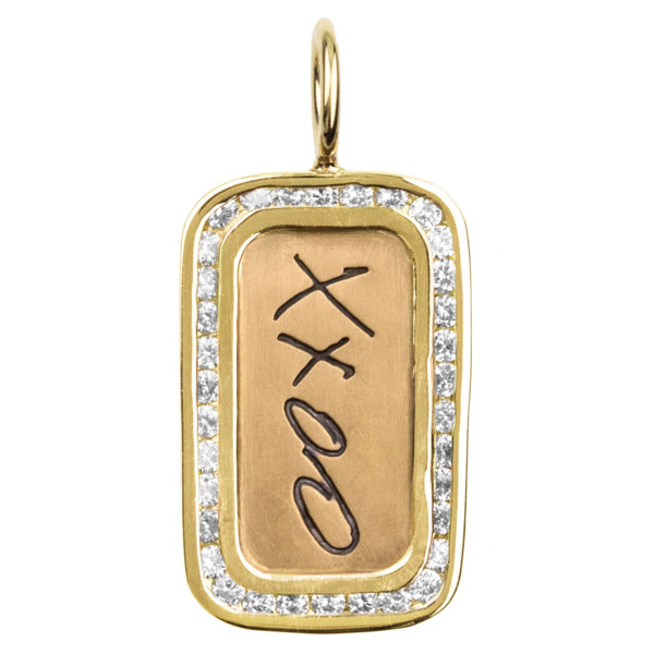 Closeup photo of XXOO Yellow Gold Channel Set ID Tag