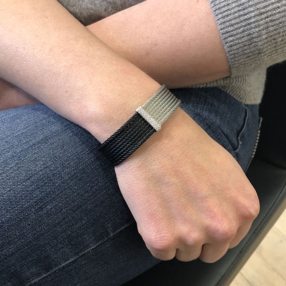 This heat treated steel cable features two colors, black and grey cable with an 18k white gold bar of diamonds right where the colors meet together. The total carat weight is .34cts, which make this cuff a must have for everyday use. Noir Two Tone Cuff