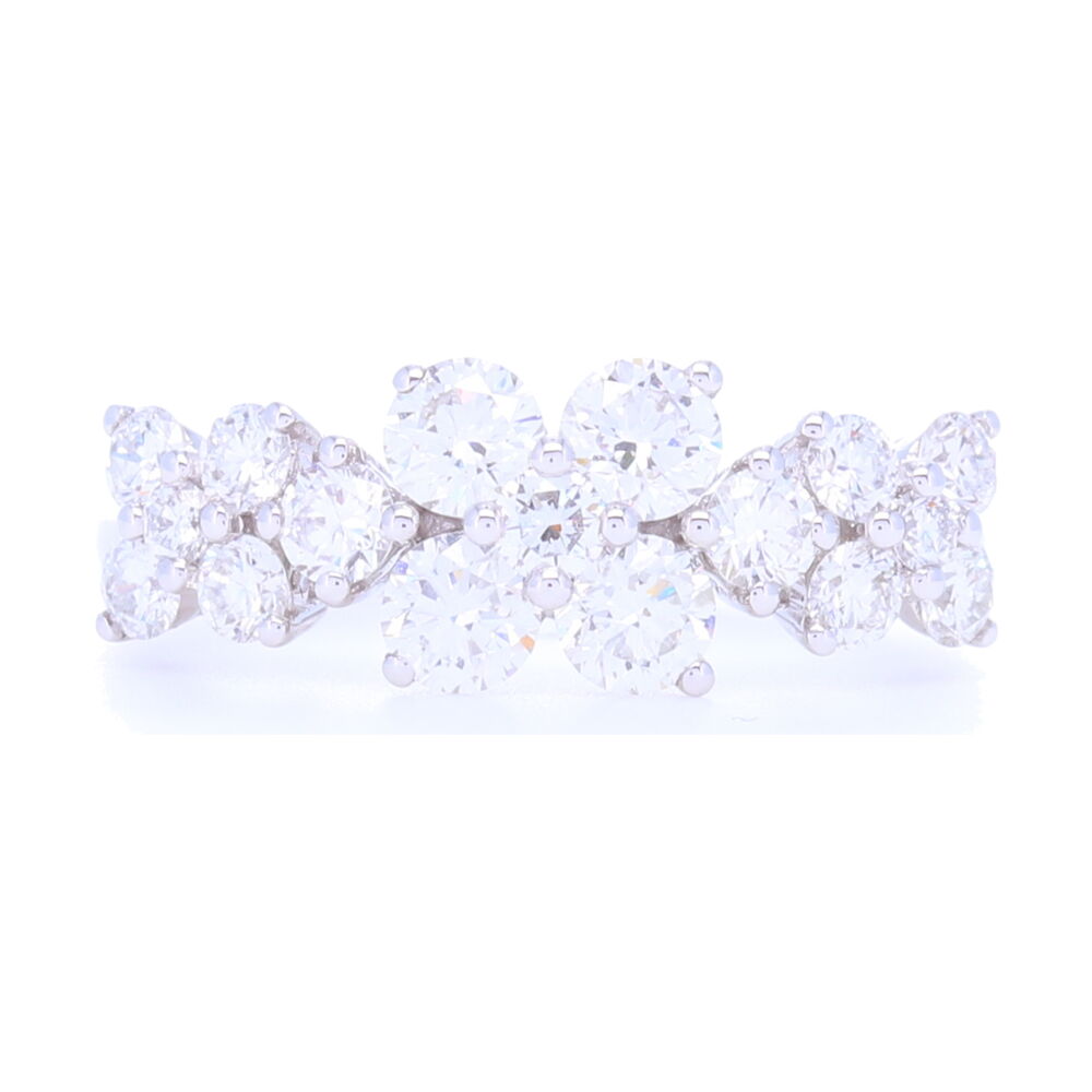 Beautiful round diamonds mimic marquise flower petals in a pattern that goes 1/2 way around this 18k gold white ring. We categorized this as stack-able due to the fact that our customers have purchased this as a wedding ring in the past. It's a huge look with 1.46 carats of diamonds set into 3.32 grams of 18k gold.<div>Diamond Weight: 1.46ct</div> 18k White Gold 3 Flower Pattern Diamond Ring