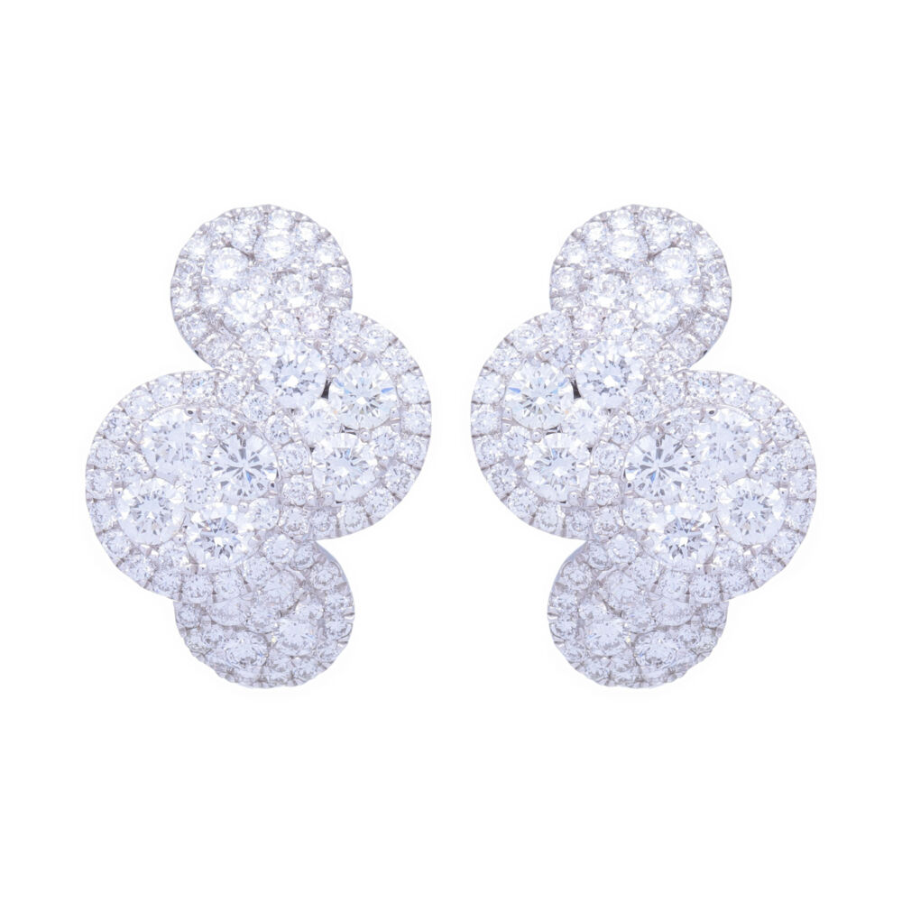 This pair of earrings has 2.3 carats of diamonds set into 18k white gold. These earrings will not get lost in your hair as they can be seen from what seems like space. Stunning white color - and comfortable to wear. Easily turn these into your every day earrings because you'll forget you have them on.<div>Diamond weight: 2.3ct</div> 18k White Gold and Diamond Clustered Circle Huggie Hoop Earrings