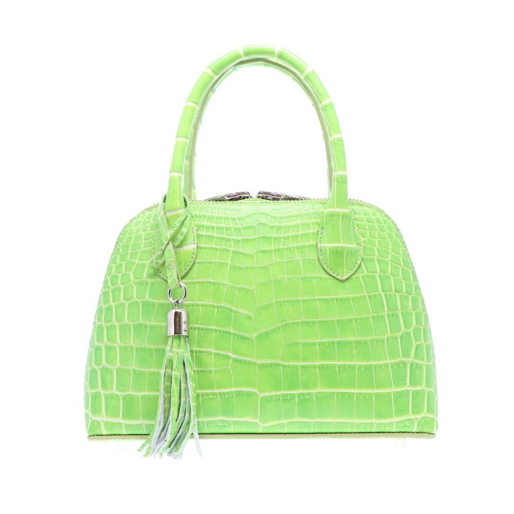 LaNae’s Small Dome is a top handle bag made of genuine Crocodile Skin. Proudly handcrafted in the USA by 3rd generation artisans, all edges are hand painted, interior is garment suede and is detailed with Italian palladium hardware. This classic style comes with a fun tassel that can be detached. The interior has a zippered and a cell phone pocket. Under the handles are D rings to attach the over the shoulder strap (up to 25”). Each luxury bag is one of a kind and especially made for you to stand out against the crowd!
Lime Crocodile in Small Dome