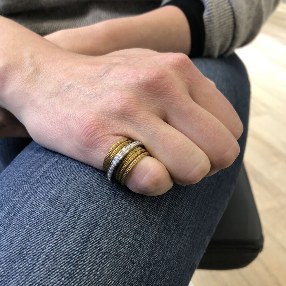 This heat treated 6 strand yellow colored heat treated steel cable ring, features a center 18k white gold band displaying a row of diamonds totaling a total weight of .09 carats. This simply elegant ring is hugs the finger perfectly and will be your next everyday favorite. Diamond Band & Stacked Ring