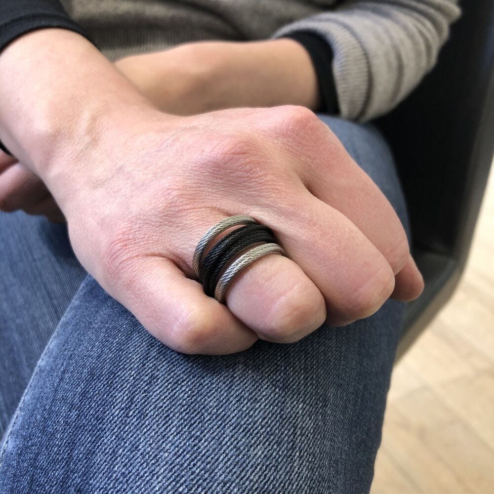This heat treated grey and black steel cable ring has two grey strands making up the top and bottom bands. The middle band is comprised of 6 strands of black cable, making this ring a perfect start to stacking. Lightweight and durable, the comfortability will make you fall in love with this ring. Noir Multi-Cable Separated Stack Ring