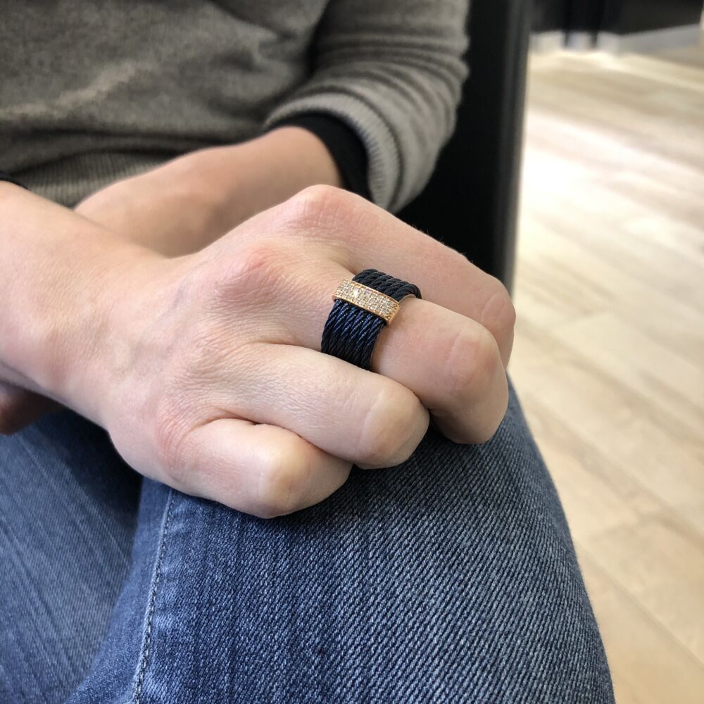 This heated treated steel cable has a beautiful blueberry color. Displaying 6 strands of cable with an 18k rose gold setting and a total diamond weight of .23 carats. This lightweight and classy ring will be perfect for everyday use. Blueberry Stacked Multi-Cable Ring