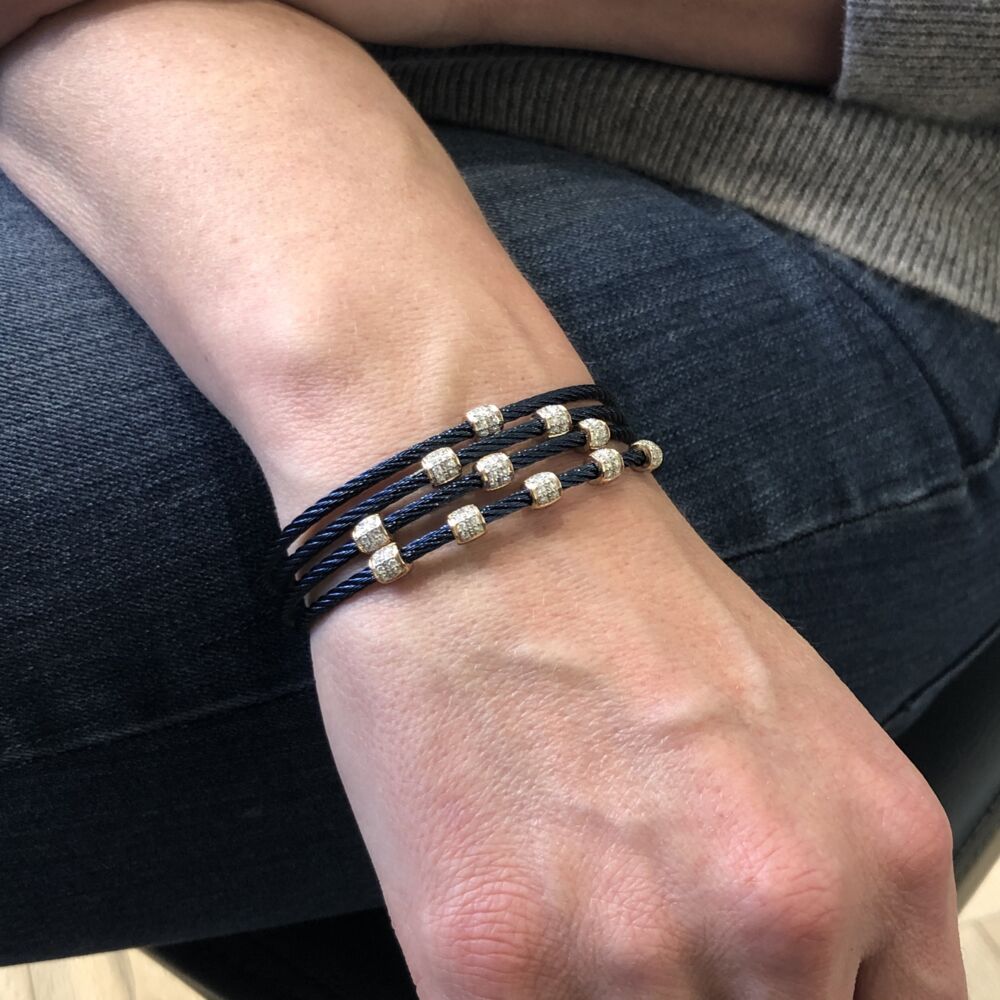 <div>This blueberry colored heat treated steel cable features three ovaled diamond stations, with a total carat weight of .21 carats. This bangle is perfect for stacking, or just to wear alone.</div> Blueberry Three Ovaled Station Bangle