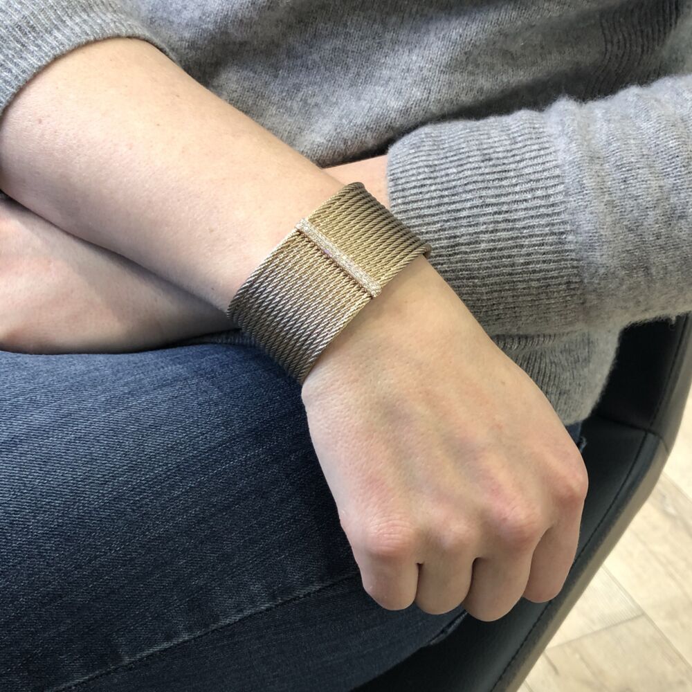 This heat treated steel carnation colored cable, features an 18k rose gold displaying a diamond bar with a total carat weight of .56 carats. Hinged to fit all wrists, this cuff can be dressed up or down making it the perfect accessory. Classique Carnation Stacked Large Cuff