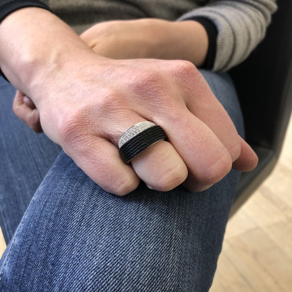 This six strand noir heat treated steel cable ring from ALOR, features an 18k white gold 1/2 band peeking out of the steel cable. Displaying a total diamond carat weight of .36 carats, making this ring simply elegant for any occasion. Noir Peekaboo Ring