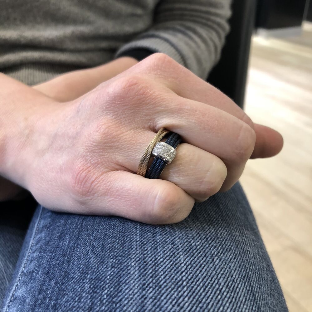 <div>This two toned blueberry and carnation ring features one band of blueberry and one band of carnation colored heat treated steel cable. One 18k white gold station sits on the blueberry cable with three rows of set diamonds weighing a total of .16 carats. This ring gives the appearance of two stacked rings, but in actuality is just one, making for a more comfortable outing. </div> Two Tone Cable Stack Ring