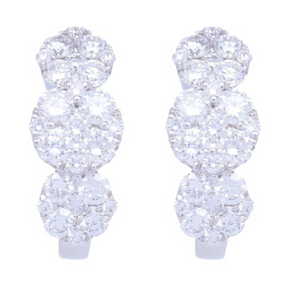 18k white gold, brilliant cut diamond cluster circle pattern hoops. Perfect for every day, sits close to the ear, doesn't get caught in your hair but has a ton of sparkle. Diamond carat weight is 1.88. 18k White Gold Circle Station Cluster Diamond Hoop Earrings