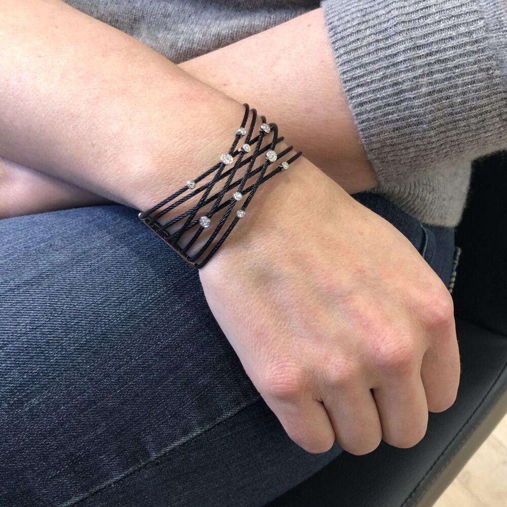 This noir heat treated steel cable features 8 strands of cable connected by two bars on either side. Displaying 10 alternate sized 18k white gold diamond stations with a total weight of .23 carats. Whether worn for a night out on the town or roaming around casually during the day, this diamond cuff is perfect for every occasion! Noir Constellation Bracelet